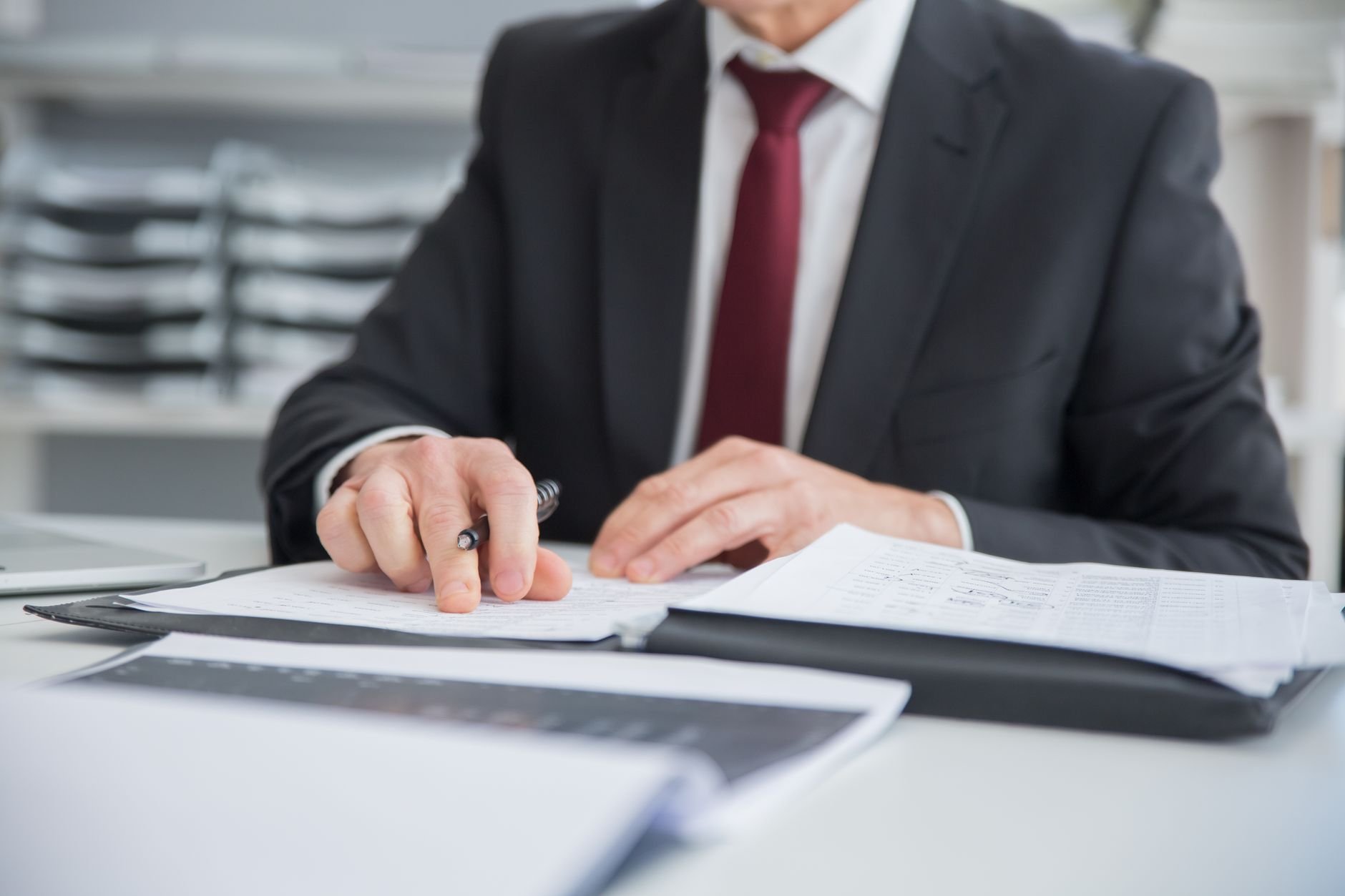 Property manager reviewing building documents at a professional desk